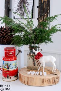 My Christmas farmhouse homes tour, featuring a sled centerpiece, vintage hat boxes, fresh cut greenery and pops of red and green.