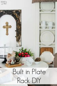 Kitchen cubbies get a makeover into a built in plate rack filled with gorgeous goodies like white and wood. White plates, cutting boards and antique tea and coffe pots. This simple DIY will help you transform small shelves into functional display space.