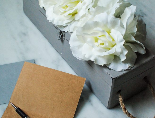 An old wine gift box transformed into a blooming storage box with dollar store flowers. PLUS five other DIY dollar store ideas with flowers.
