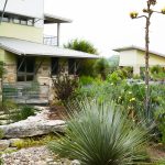 Visit the garden of a sleek rustic modern home with breathtaking views around every corner, agave and native vegetation, infinity pool and pecan orchard all overlook the Brazos River in the distance.