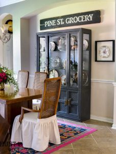 French Cajun dining room décor ideas inspired by Empress Dresden Flowers China pattern. Dining room ideas to including a gray painted china hutch and pink rug.
