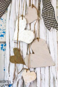 Create boho chic wall hanging decor from your old linens. Purging the linen closet will provide tons of great crafting material. This DIY wall hanging is dressed up for Valentine's Day, but would be great for a farmhouse feel any time of year. WIth great texture from burlap, drop cloth and tin foil this tone on tone neutral decor is a versatile addition to any style, Simple natural touches round out this Valentine home tour.