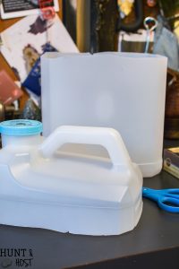 Turn your empty kitty litter jugs into cute storage buckets. Upcycling empty containers for inexpensive DIY organizing is quick and easy!