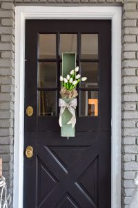 This white tulip wreath for the front door would look great as wall art too. Perfect for your spring decor this upcycled vintage safety deposit box was a unique Round Top Antiques Week find.