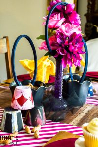 Create a table setting inspired by The Greatest Showman! Perfect for a glam circus theme dinner or just for a cute Greatest Showman tablescape to entertain the family. Anne's pink hair and the smell of peanuts round out this glitzy gold and fuchsia party scene.