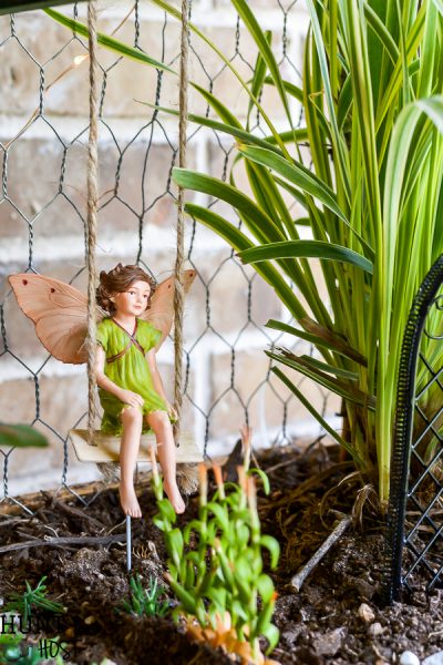 Take your fairy garden vertical with this natural fairy garden setting, complete with an actual fairy garden and swimming hole. This fun summer project to do with the kids will get your creativity going and green thumb working. Make a mini fairy garden for your house or porch with these precious fairy supplies and easy miniature ideas!