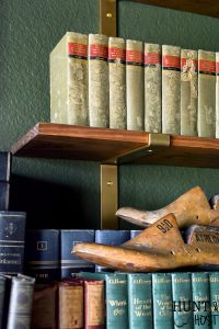 Built in cabinets can be expensive, read all the reasons to use open shelving vs built-in storage for a more stylish and affordable home. Make your study or library room cozy and charming with this moody green paint and faux built-in. #fremchcountrycottage #libraryroom #openshelf #storageideas #DIYcabinet #DIYstorageidea #frenchcountryoffice