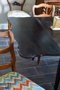 This $40 Facebook Marketplace find gets a makeover. See how this filthy drop leaf dining room table goes to French Country gorgeous in no time. With large print houndstooth fabric and a deep dark paint job these charis are stunning. #frenchcountry #diningroom #cottagedinginroom #farmhousediningroom #paintedfurniture