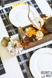 A simple fall table setting with buffalo plaid accents via chalkboard placemats. Layer on the metallic ad gold hues that are popular fall colors this year! CHeck out an entire array of simple fall décor inspiration from mantels to free printables, this post has it all! #chalkboard #meatllics #falltable #gourds #simplefall