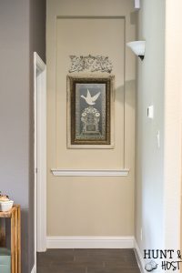 Taking your boring art niche up a notch with this quick afternoon makeover. How to install peel and stick wood tiles to decorate a small space with rustic style. #woodtile #artniche #rusticdecor #woodwall #easyshiplap