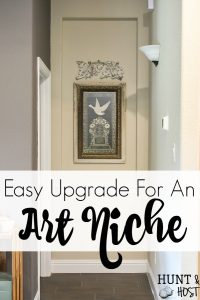 Taking your boring art niche up a notch with this quick afternoon makeover. How to install peel and stick wood tiles to decorate a small space with rustic style. #woodtile #artniche #rusticdecor #woodwall #easyshiplap