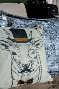 This dapper deer pillow is a must have for a whimsical french country vibe or farmhouse style living room. Add charm with this deer pillow without spending a ton of money! #deerpillow #farmhousepillow #vintagevibe #dapper #eclecticpillow