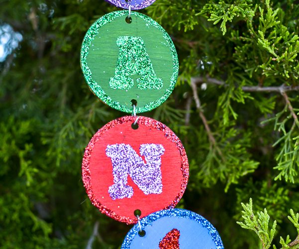 Make your own personalized Christmas ornament with your name, your kid's name or just fun Christmas sayings and words. This easy DIY takes no special tools or machines. You can make custom christmas ornaments to fit your color scheme and any name, even a christmas ornament for unusual names! Everyone loves to see their name in glitter and on the Christmas tree so make these special ornaments for the whole family. #handmadechristmas #christmastreeornaments #decoratethetree #nameinlights #DIYChristmasornament #glitter #easy #simpleChristmas
