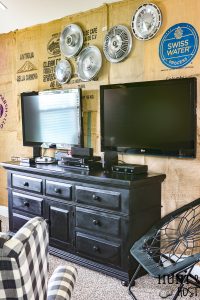 What a great game room idea! This rustic cabin lodge game room has great decorating ideas. a tutorial on how to hang a wall mounted TV (or two for a Fortnight lover's paradise!) plus an inexpensive DIY burlap wall covered in coffee bean sacks. All the elements for the perfect family game room with a cozy cabin style! #SANUS #SANUSspaces @SANUS @SANUSsystems #gameroomideas #burlapwalls #DIYwallpaper #mediaroom #TVmount #rusticroom #familyroomideas #rusticdecorideas