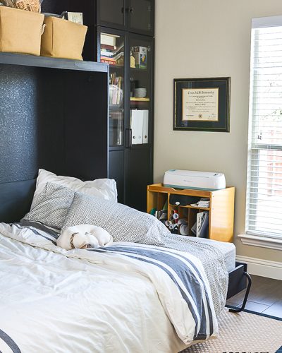 We added a Murphy bed to the craft room/guest bedroom and it is a space saver for sure. See how we paired the IKEA Billy bookcase with a custom Murphy bed for an office/craft/spare room with tons of functional storage and style. #IKEA #craftroom #murphybedidea #WhereWomenCreate #craftroomidea