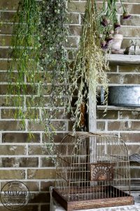 Get a French country porch with this vintage flower drying rack idea, perfect for drying herbs and adding a beautiful focal point to your outdoor patio. #wildflower #frenchporch #DIYherbdrying #plantdrying #plantdryingrack #herbgarden #porchquiltdiy #vintagegarden #outdoorlivingidea #outdoordecorating