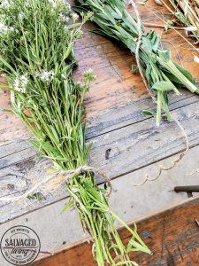 Get a French country porch with this vintage flower drying rack idea, perfect for drying herbs and adding a beautiful focal point to your outdoor patio. #wildflower #frenchporch #DIYherbdrying #plantdrying #plantdryingrack #herbgarden #porchquiltdiy #vintagegarden #outdoorlivingidea #outdoordecorating