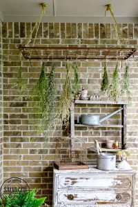 Get a French country porch with this vintage flower drying rack idea, perfect for drying herbs and adding a beautiful focal point to your outdoor patio. #wildflower #frenchporch #DIYherbdrying #plantdrying #plantdryingrack #herbgarden #porchquiltdiy #vintagegarden #outdoorlivingidea #outdoordecorating