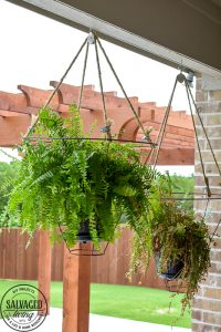 Looking for an unusual outdoor hanging basket for your favorite patio plants? This vintage lampshade makes the perfect hanging basket and is a simple upcycle for your porch. #outdoorhangingbasket #industrialvintageporch #lampshadeideas #DIYplanthanger #diyhangingbasket #outdoorpatiodecor #fern #vintageporch