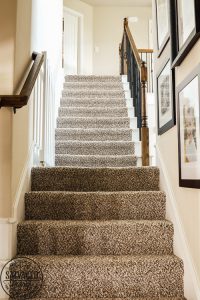 How to build a stylish stairway gate to keep pets or kids out! This easy DIY gate tutorial will look great and blend with your traditional decor. We keep our dog off the carpet with this pet gate. #petgate #stairgate #childproof #DIYpet #cleancarpet #doggate #petgatediy #petgateforstairs