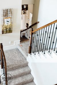 How to build a stylish stairway gate to keep pets or kids out! This easy DIY gate tutorial will look great and blend with your traditional decor. We keep our dog off the carpet with this pet gate. #petgate #stairgate #childproof #DIYpet #cleancarpet #doggate #petgatediy #petgateforstairs