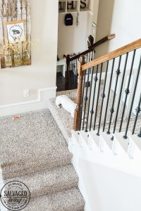 How to build a stylish stairway gate to keep pets or kids out! This easy DIY gate tutorial will look great and blend with your traditional decor. We keep our dog off the carpet with this pet gate. #petgate #stairgate #childproof #DIYpet #cleancarpet #doggate #petgatediy #petgateforstairs