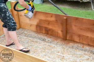 Learn how to spray stain on wood along with tips on how to clean your srpayer when you spray an oil based stain. HINT: it is so much easier than you think! This DIY raised garden bed got a spray stain that will help the wood look good and last longer and it only took minutes to do,. #wagnerspraytech #spraystain #oilbasedstain #paintcleanup #sprayertips #stainedwood #flowergarden #vegetablegarden #raisedbed #landscapedecor #fencestain #diyfencestain