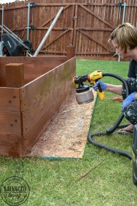 Learn how to spray stain on wood along with tips on how to clean your srpayer when you spray an oil based stain. HINT: it is so much easier than you think! This DIY raised garden bed got a spray stain that will help the wood look good and last longer and it only took minutes to do,. #wagnerspraytech #spraystain #oilbasedstain #paintcleanup #sprayertips #stainedwood #flowergarden #vegetablegarden #raisedbed #landscapedecor #fencestain #diyfencestain