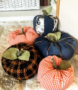 If you've ever wondered how to make easy fabric pumpkins this is the post for you! I am going to show you three ways to make fall pumpkins for your home decor, including a no sew fabric pumpkin tutorial! Your house can be full of farmhouse stuffed pumpkins on a budget. #diypumpkins #fallhomedecor #fallcraftidea #nosewpumpkin #diypumpkinpattern #shabbychicpumpkin #pumpkintutorial #cozyfallhome