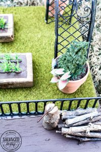 Tour a miniature vintage garden shop dollhouse for great ideas for your own dollhouse decor. See how to make a cozy home, lush garden and outdoor miniature yard! COmplete with garden gnomes, miniature potted plants and sitting areas. #dollhouse #miniatures #DIYdollhouse #vintagegarden #tinydecor