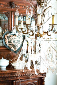 Create a romantic table for Valentine's Day on a tight budget with tons of dollar store crafts mixed with vintage items to bring together a romantic picnic...inside! Bringing the outdoors is always a stylish budget friendly option for holiday decorating! #valentinesdaydecorations #valentinesdaycrafts ##valentinesdaydollarstore #romantictable #farmhousevalentinesday