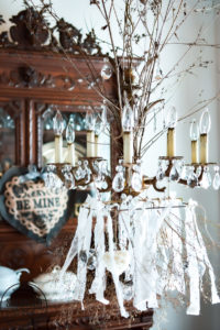 Create a romantic table for Valentine's Day on a tight budget with tons of dollar store crafts mixed with vintage items to bring together a romantic picnic...inside! Bringing the outdoors is always a stylish budget friendly option for holiday decorating! #valentinesdaydecorations #valentinesdaycrafts ##valentinesdaydollarstore #romantictable #farmhousevalentinesday