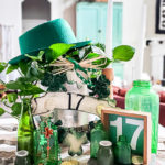 St. Patrick's Day decor ideas from the Dollar store. Use this cute St. Patrick's day wreath tutorial and St. Patrick's Day home decor styling idea to create a cute green space in your home! Mix old, vintage items with dollar store decor for a classic St. Paddy's day look. #stpatricksday #dollarstorecraft #budgetdecoridea