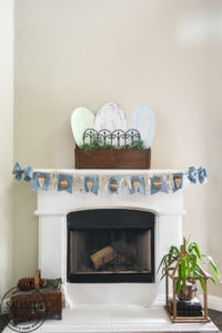 Decorate your mantle for Easter with this budget Easter mantle decorating idea from cardboard! Seriously the best budget decorating hack there is , so easy and you can paint it any color or style. Also tips to make an Easter banner from dollar store items and things you have on hand at home already. #budgetdecor #eastermantle #easterdecoratingideas #dollarstorecraft #dollartreedecor