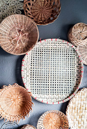 everything you need to know about creating basket gallery wall art. Where to find vintage baskets, how to hang baskets and how to layout a basket gallery wall are all here in this gorgeous gallery wall trend idea. #vintagedecor #wovenbaskets #basketwall #gallerywall