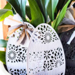 Try this easy idea for dollar store yard decor for Easter. You can get a fun farmhouse look for Easter decorations with this budget friendly Easter craft. I like to add yard decor to potted plants on my patio or potted plants inside. Who says yard art has to stay outside? #yarddecor #dollartreecraft #eastercraft #easterdecoridea