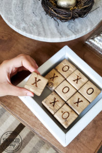 Learn how to make a DIY tic tac toe game from 4 X 4 posts that is so gorgeous you will want to display it, inside or out. This pretty tic tac toe board makes a perfect DIY gift, budget friendly! #tictactoe #woodproject #scrapwood