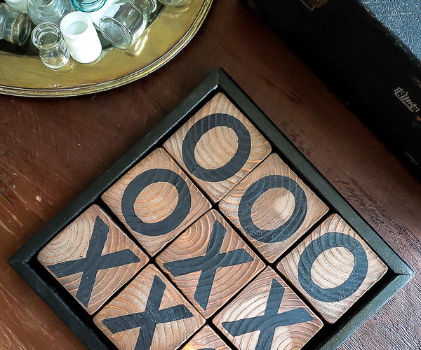 Learn how to make a DIY tic tac toe game from 4 X 4 posts that is so gorgeous you will want to display it, inside or out. This pretty tic tac toe board makes a perfect DIY gift, budget friendly! #tictactoe #woodproject #scrapwood