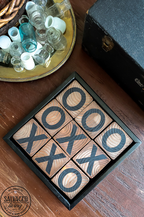 Learn how to make a DIY tic tac toe game from 4 X 4 posts that is so gorgeous you will want to display it, inside or out. This pretty tic tac toe board makes a perfect DIY gift, budget friendly! #tictactoe #woodproject #scrapwood
