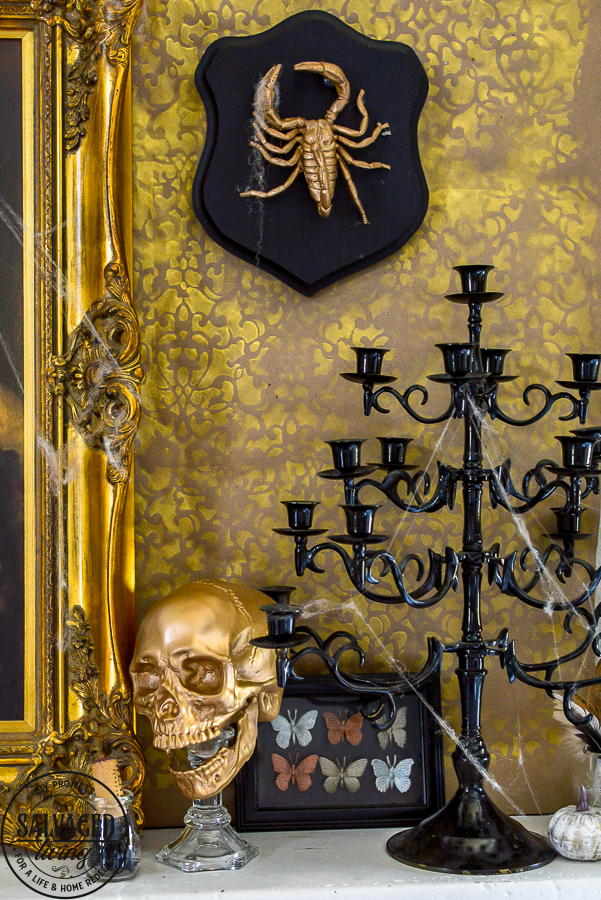 welcome to the Haunted Midas Mansion. These easy DIY Halloween mantel decoration ideas will inspire you to create an elegant Halloween home decor aesthetic that is a little bit vintage, kind of spooky and tons of fun. #indoorHalloween #Halloweendecorating #goldHalloweendecor 