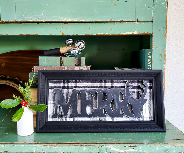 Make a dollar store Christmas sign in no time that looks like gorgeous farmhouse CHristmas decor. This simple dollar tree craft uses an old picture frame to mix old and new for gorgeous dollar store home decor for Christmas. #dollartreecraft #dollartreechristmas #dollarstoreholiday #budgetChristmasdecor #framemakeover