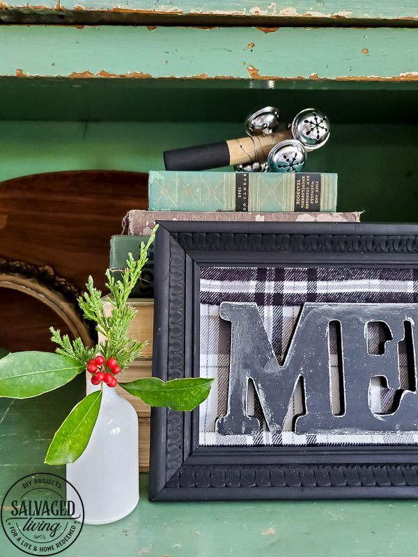 Make a dollar store Christmas sign in no time that looks like gorgeous farmhouse CHristmas decor. This simple dollar tree craft uses an old picture frame to mix old and new for gorgeous dollar store home decor for Christmas. #dollartreecraft #dollartreechristmas #dollarstoreholiday #budgetChristmasdecor #framemakeover