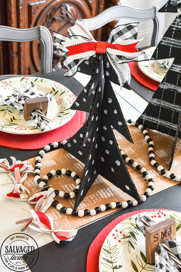 Amazing budget friendly Christmas decorating ideas including a chalkboard Christmas tree made out of cardboard. Cardboard craft ideas to use in your holiday decorating that are so adorable, like a glittery plate charger, ribbon table runner and more ideas to try. #buffalocheck #chalkboardcraft #DIYChristmas #cardboardcraft