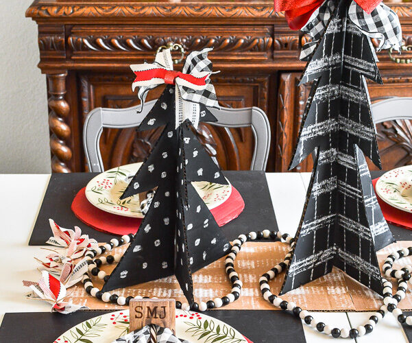 Amazing budget friendly Christmas decorating ideas including a chalkboard Christmas tree made out of cardboard. Cardboard craft ideas to use in your holiday decorating that are so adorable, like a glittery plate charger, ribbon table runner and more ideas to try. #buffalocheck #chalkboardcraft #DIYChristmas #cardboardcraft