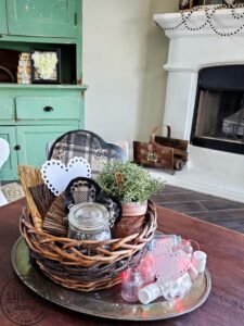 Learn how to make gorgeous giant paper hearts for Valentine's Day decorating on repurposed spindle stands. This dollar store craft is perfect for a farmhouse Valentine theme. #vintageValentine #upcycledprojectidea #spindle #papercraft #stencilart #valentinesdaymantel