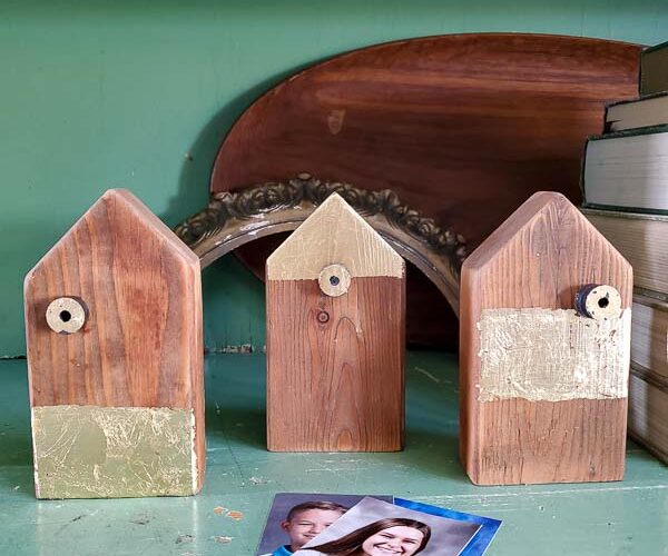 Make your own scrap wood picture holder house with this easy DIY that takes home made up anotch with gold leaf gilding for a modern touch on rustic charm for a great way to display kid's school pictures in style! #schoolpicture #scrapwoodproject #pictureframeidea #goldleafproject