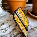 Wonder what to do with old door hinges? Try this upcycled door hinge butterfly project for a fun and beautiful addition to your spring decor ideas. These painted butterflies are perfect for your patio and potted plants. Truly adorable yard art you can DIY with thrifted or left over materials! #butterflyart #doorhinge #upcycledcraft #springdecor #springcraft