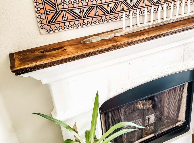 See how to make a stone fireplace mantel into a wood fireplace mantel. This DIY mantel idea is perfect for the person who loves to decorate their mantel but struggles with how to hang deocr on stone mantel or concrete mantel. It is an easy fireplace fix for a more functional fireplace mantel. #woodmantel #DIYmantel #manteldecor #stonefireplaceidea