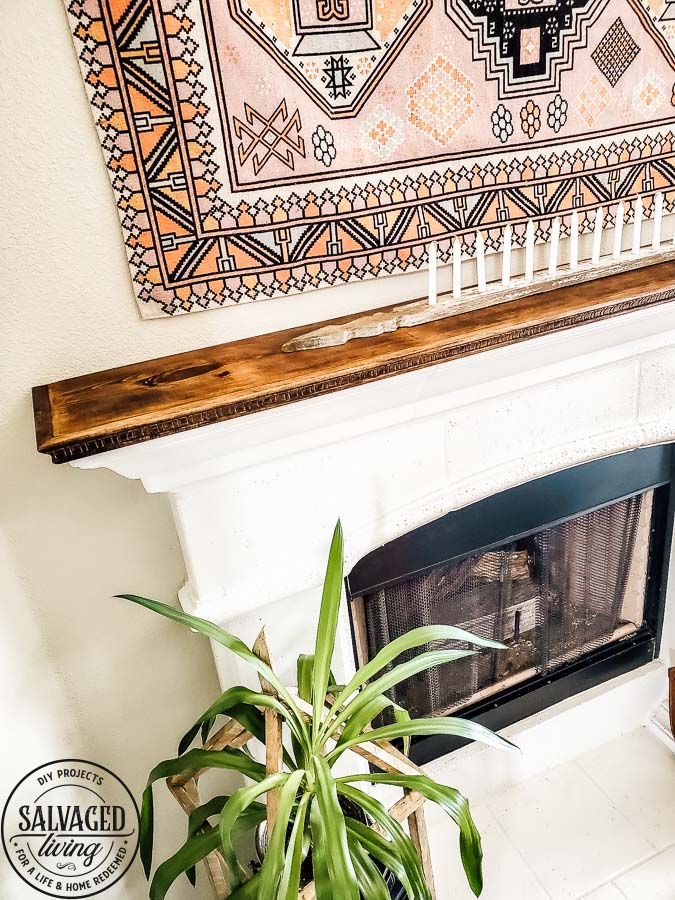 See how to make a stone fireplace mantel into a wood fireplace mantel. This DIY mantel idea is perfect for the person who loves to decorate their mantel but struggles with how to hang deocr on stone mantel or concrete mantel. It is an easy fireplace fix for a more functional fireplace mantel. #woodmantel #DIYmantel #manteldecor #stonefireplaceidea 