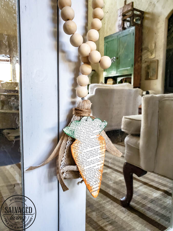 Dollar store wood cutouts for easter decor, this cute dollar Tree carrot craft is a beautiful way to add a wood bead tassel to your spring decor. #dollarstorecraft #dollartreedecor #woodcutout #beadgarlandDIY #DIYtassel